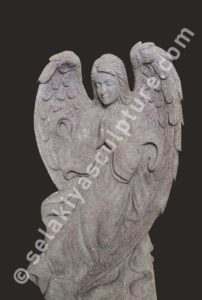 Angel garden sculpture. White marble. Female angel with flowing hair and wings. Standing in garden. Serene expression.